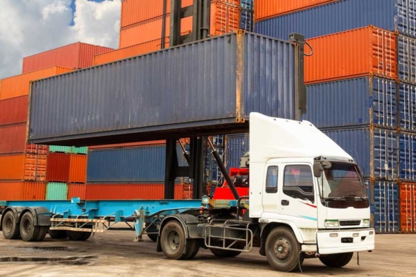 A Truck with a stack of Shipping Containers