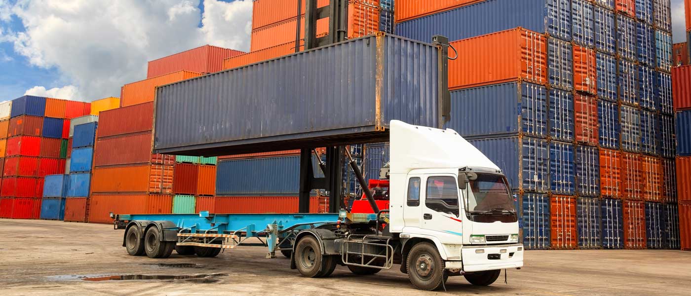 A Truck with a stack of Shipping Containers