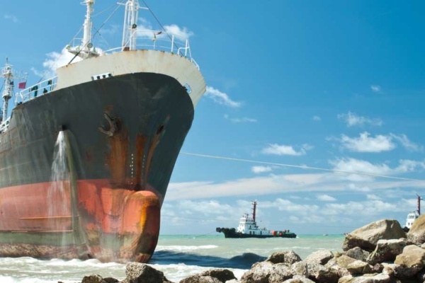 Cargo ship run aground on rocky shore