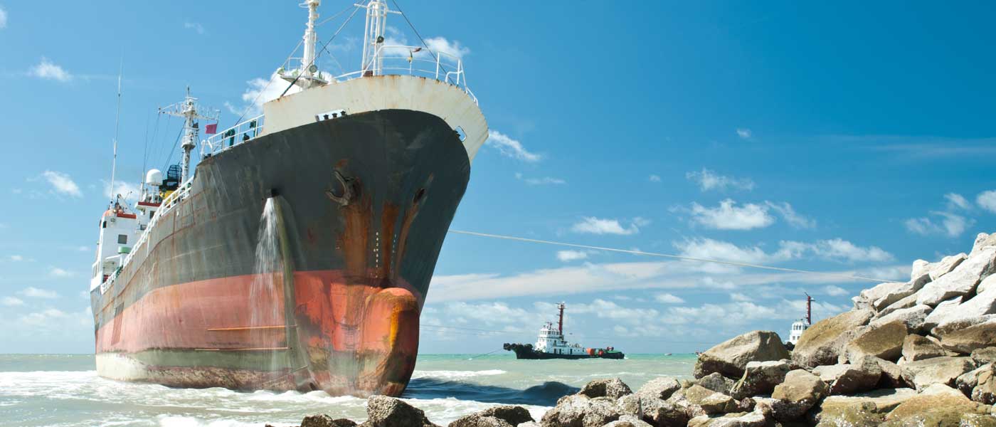 Cargo ship run aground on rocky shore