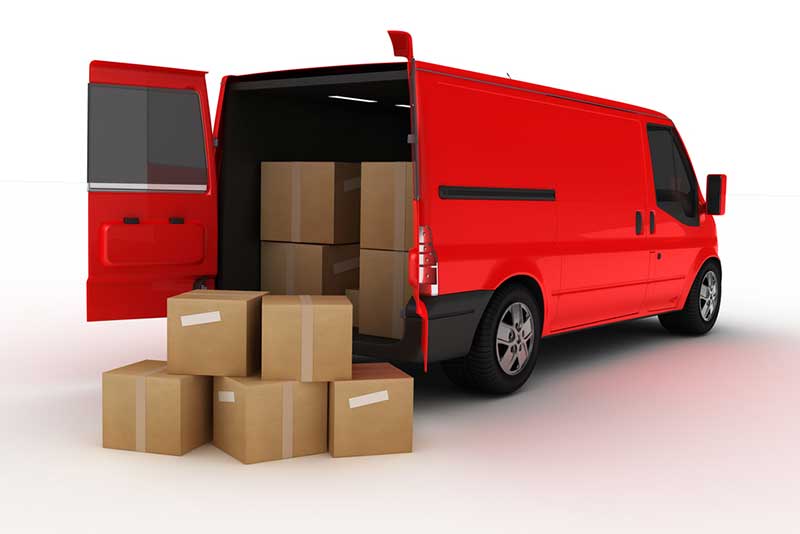 A red-colored mini-van getting loaded with boxed parcels
