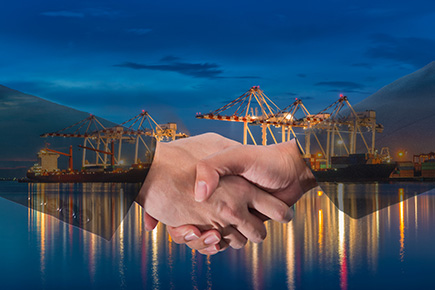 Gentle hand-shaken between two businessmen in the logistics shipment background