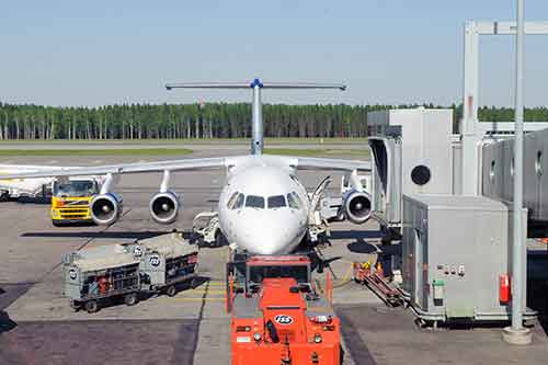 An air cargo is getting filled with freights