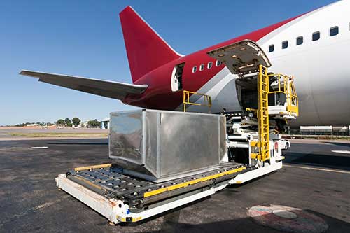 Red and white color combined air cargo is getting loaded with freight